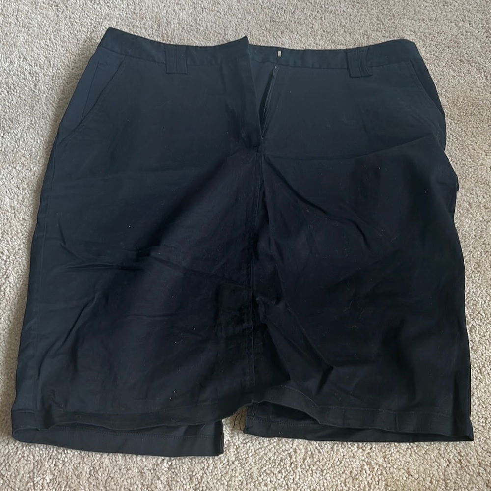 Black skirt with cut out detail in the back and button pockets in the back